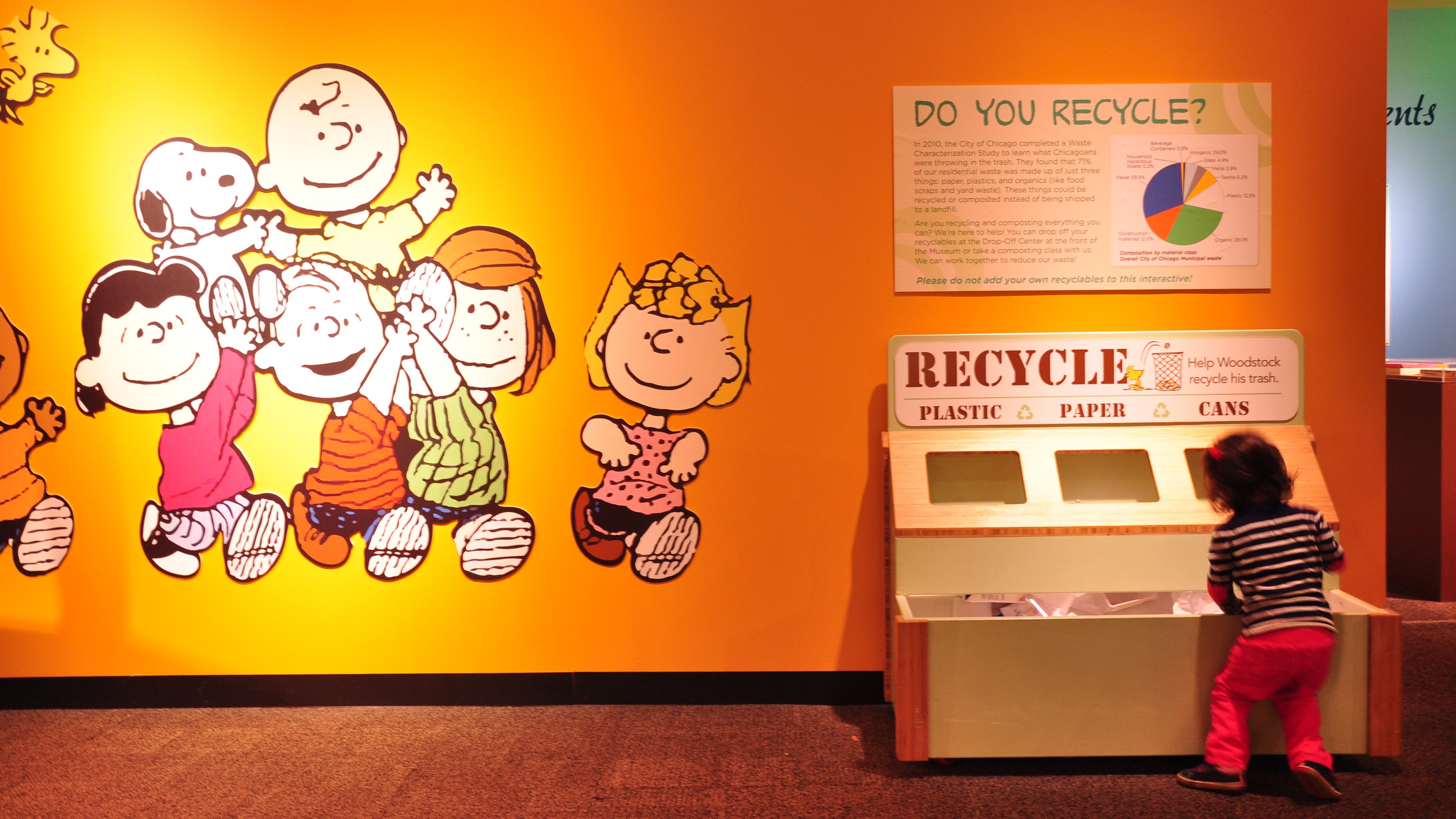 A young visitor learns about recycling at the Nature Museum's "Peanuts ... Naturally" exhibit. (Sean Keenehan)