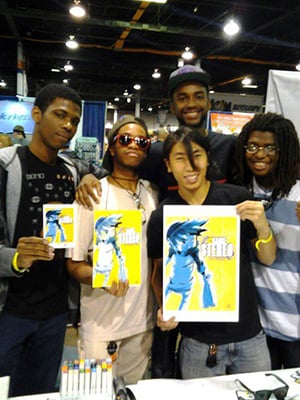 Steven Scott (back, right) and his comic team holding a copy of 12 Gauge Stereo