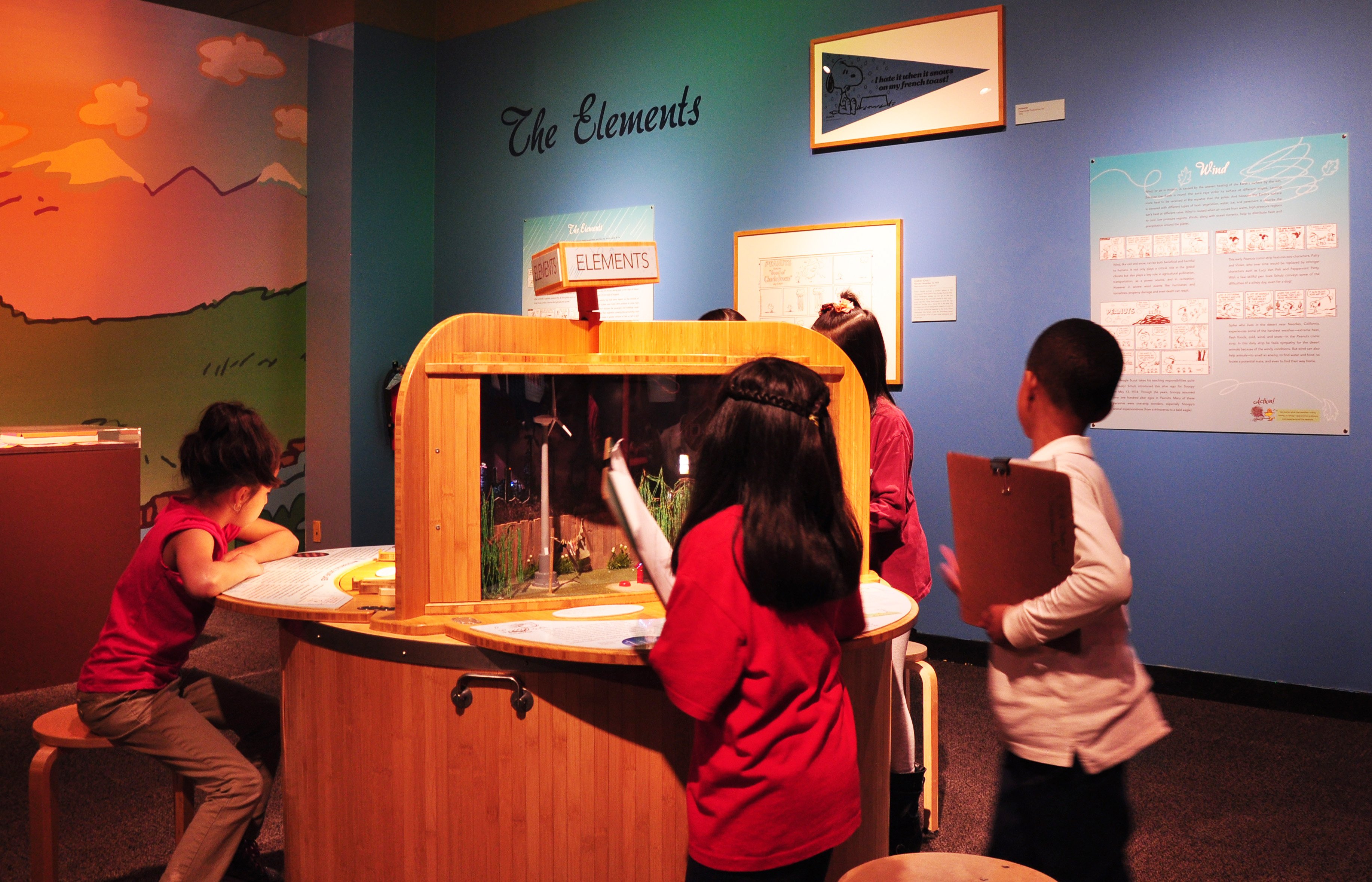Children learn about wind and other elements at the "Peanuts ... Naturally" exhibit. (Sean Keenehan)