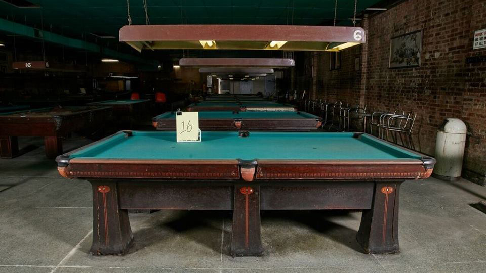 The 90-year-old Brunswick billiards tables weigh more than 2,800 pounds and can sell for as high as $15,000 when fully restored, according to professional billiards player Deno Andrews. (Courtesy of Karen McMillin) 