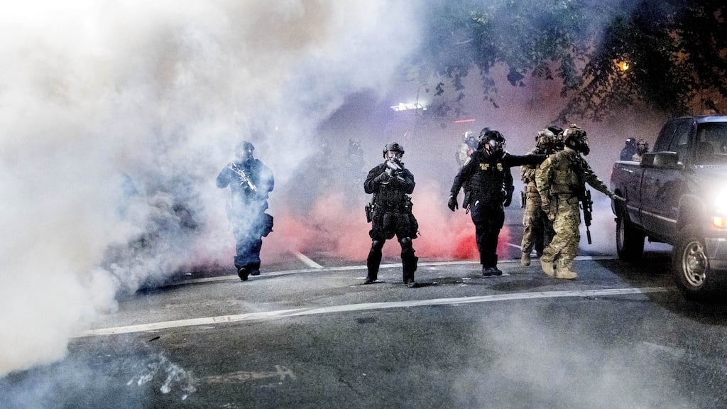 Federal officers use crowd control munitions to disperse Black Lives Matter protesters outside the Mark O. Hatfield United States Courthouse on Tuesday, July 21, 2020, in Portland, Ore. (AP Photo/Noah Berger)