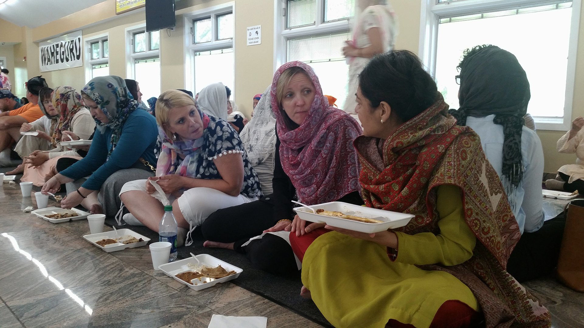 Suburban Chicago public school teachers take in the traditional “langer” meal Tuesday at the Sikh Gurdwara in Palatine. (Matt Masterson / Chicago Tonight)