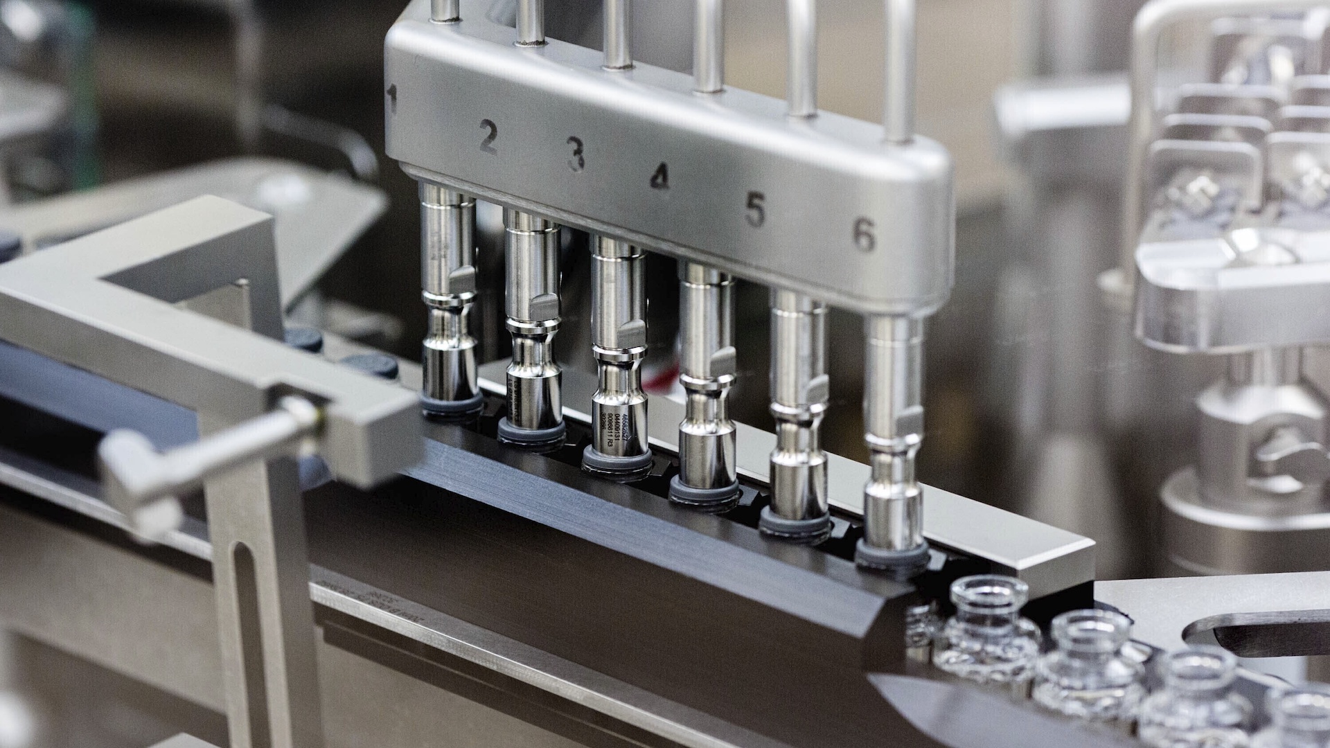 In this March 2020 photo provided by Gilead Sciences, rubber stoppers are placed onto filled vials of the investigational drug remdesivir at a Gilead manufacturing site in the United States. (Gilead Sciences via AP)