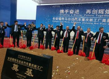Alan Mulally (fifth from left), chief executive officer of Ford Motor Co., celebrates the new Changan Ford Mazda Automobile plant in Chongqing, China, on Friday, Sept. 25, 2009. Image credit: Doug Kanter/Bloomberg