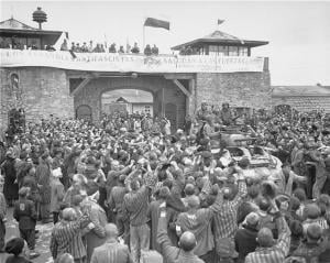 Tanks of the US 11th Armored Division enter the Mauthausen concentration camp; banner in Spanish reads "Antifascist Spaniards greet the forces of liberation". The photo was taken on May 6, 1945