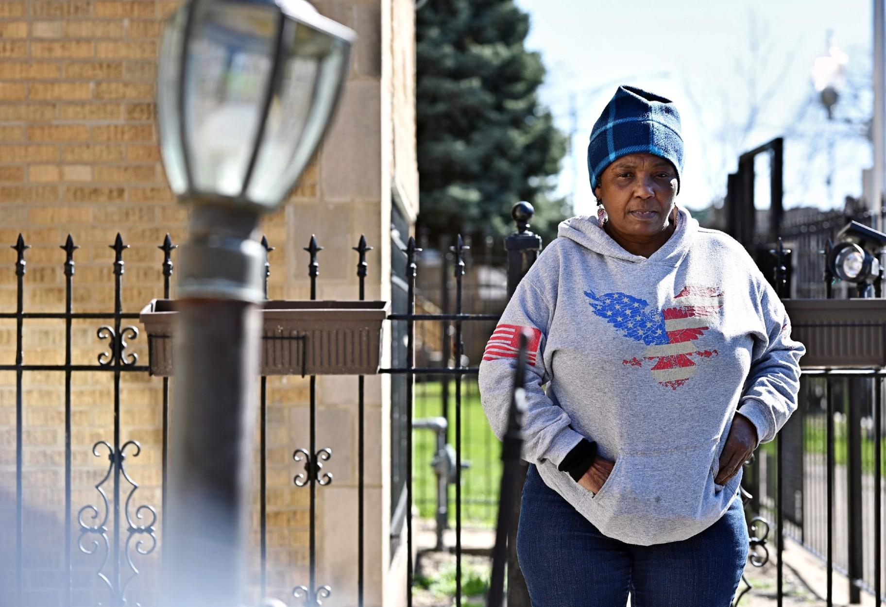 Mary Buchanan, 68, stands outside her home in West Garfield Park on March 21, 2024, examining the recent construction to her front lawn. She paid 2,000 to install a check valve to prevent waste water from flowing into her home the next time her neighborhood floods. Her basement was significantly damaged in July 2023 after a major storm. (Victor Hilitski / Illinois Answers Project)