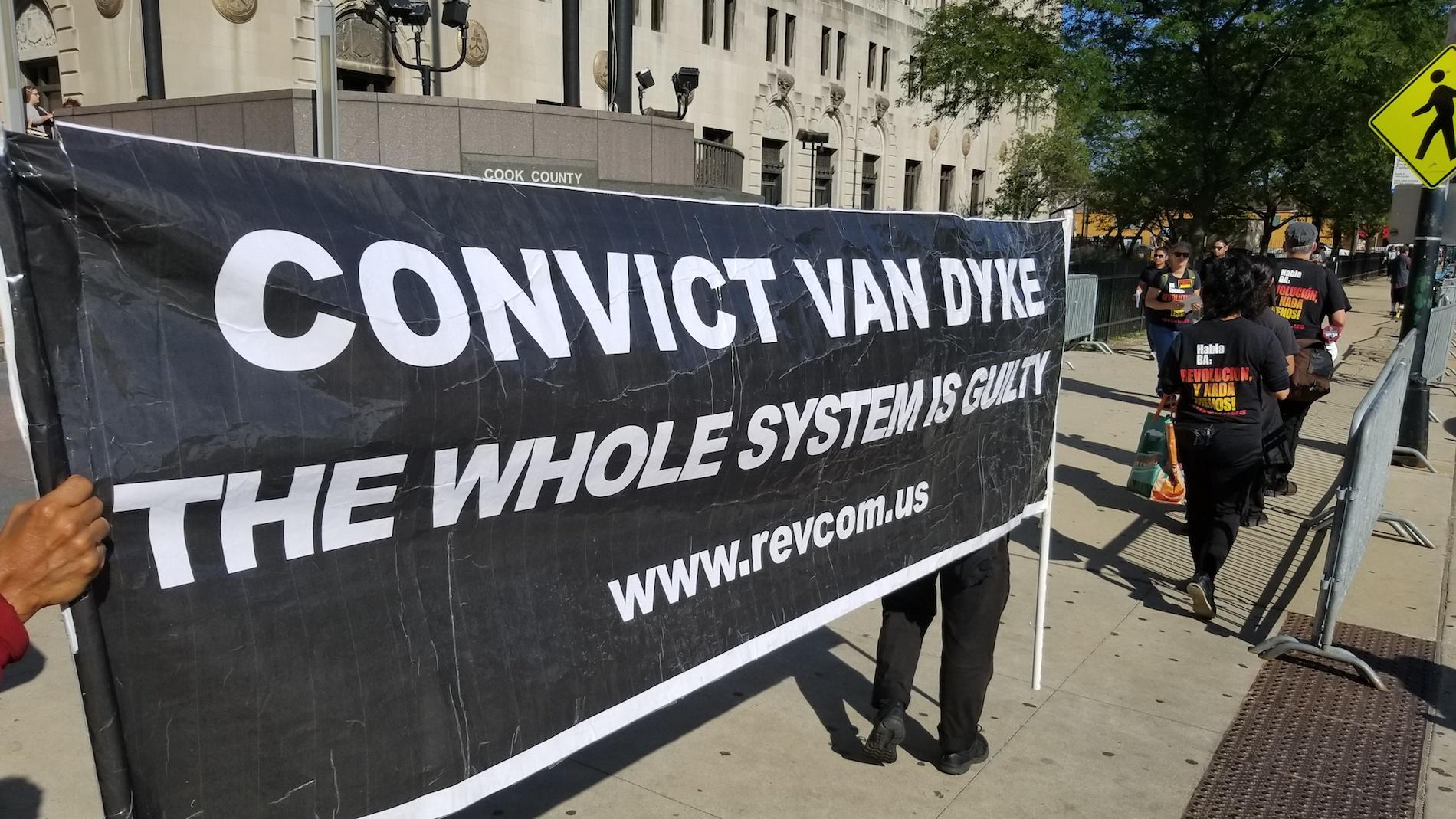 Protesters standing outside the Leighton Criminal Court building Monday on the first day of jury selection in Jason Van Dyke's murder trial. (Matt Masterson / Chicago Tonight)