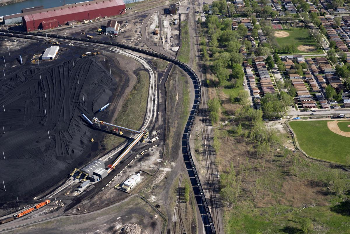 For years, piles of petcoke stored along the Calumet River resulted in thick clouds of black dust blowing through Southeast Side neighborhoods. (Terry Evans / Courtesy of Museum of Contemporary Photography)