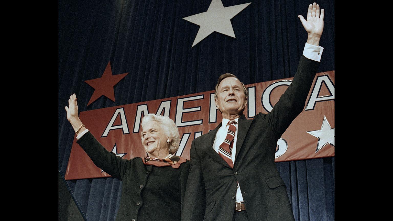 In this Nov. 8, 1988 file photo, President-elect George H.W. Bush and his wife Barbara wave to supporters in Houston, Texas after winning the presidential election. (AP Photo / Scott Applewhite, File)