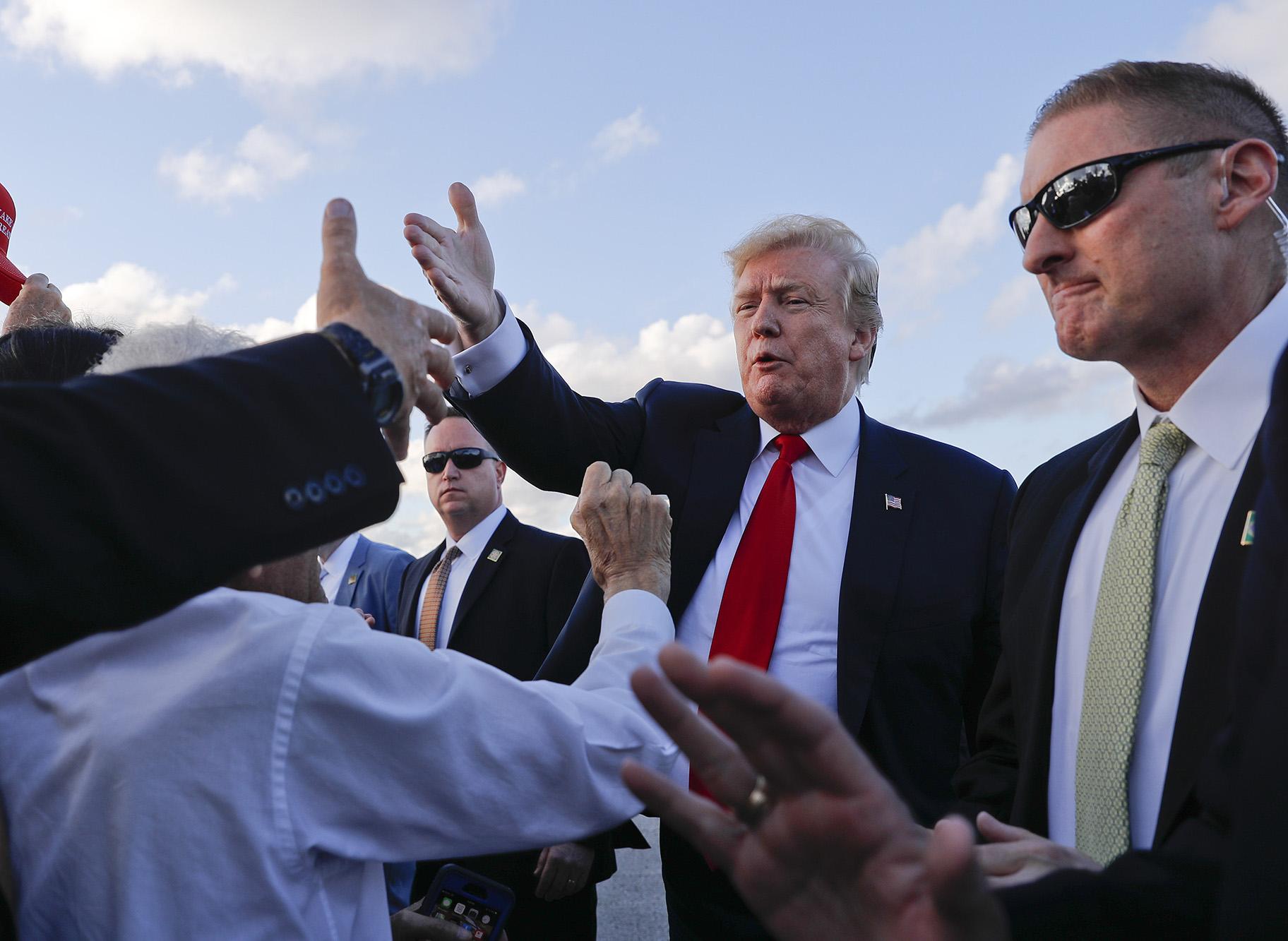 President Donald Trump reaches out to greet supporters on the tarmac upon his arrival at Palm Beach International Airport on Thursday, April 18, 2019, in West Palm Beach, Florida. (AP Photo / Pablo Martinez Monsivais)
