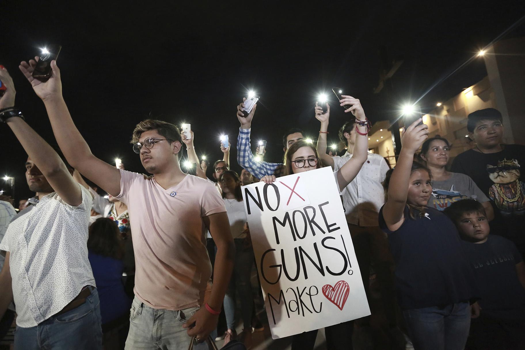 People gather in Juarez, Mexico, on Saturday, Aug. 3, 2019, in a vigil for the three Mexican nationals who were killed in an El Paso shopping-complex shooting. (AP Photo / Christian Chavez)