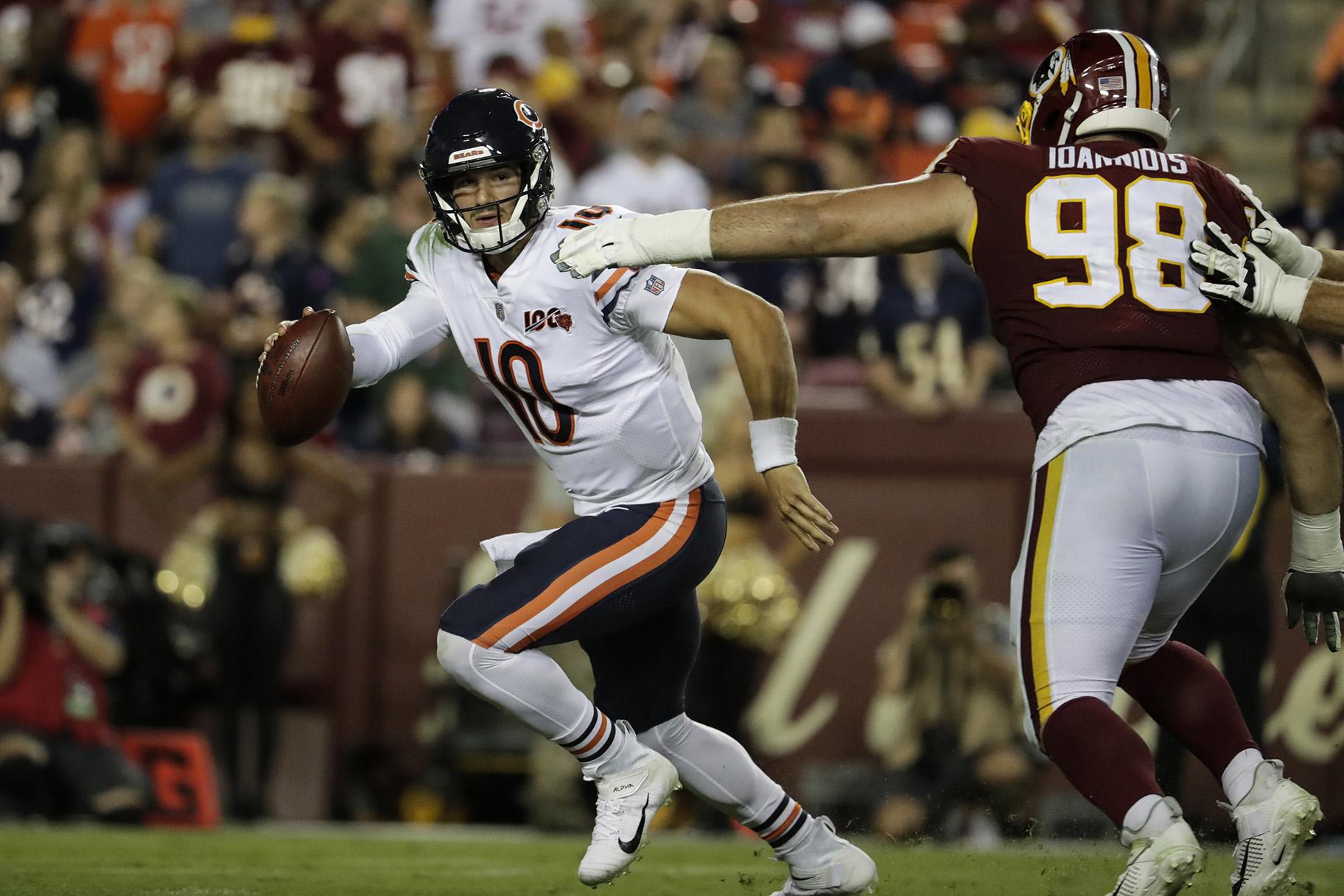 Chicago Bears quarterback Mitchell Trubisky (10) works to escape Washington Redskins defensive end Matthew Ioannidis (98) during the second half of an NFL football game Monday, Sept. 23, 2019, in Landover, Md. (AP Photo / Julio Cortez)