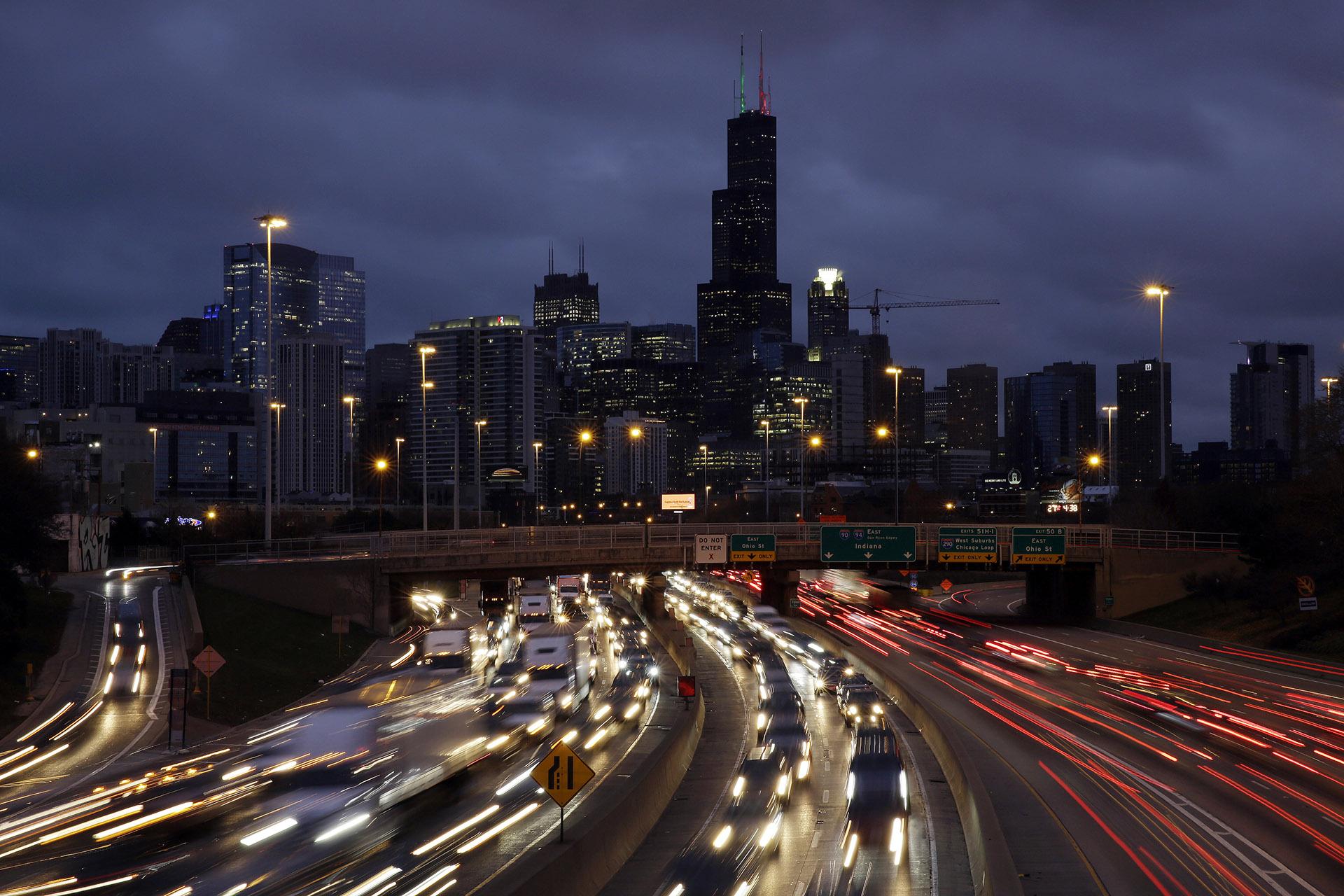 In this Nov. 21, 2018, file photo taken with a long exposure, traffic streaks across the John F. Kennedy Expressway at the start of the Thanksgiving holiday weekend in Chicago. (AP Photo / Kiichiro Sato, File)