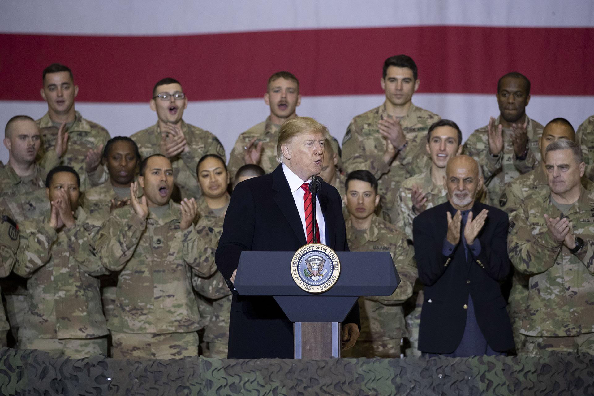 President Donald Trump, center, with Afghan President Ashraf Ghani, second from the right, and Joint Chiefs Chairman Gen. Mark Milley, right, while addressing members of the military during a surprise Thanksgiving Day visit, Thursday, Nov. 28, 2019, at Bagram Air Field, Afghanistan. (AP Photo / Alex Brandon)