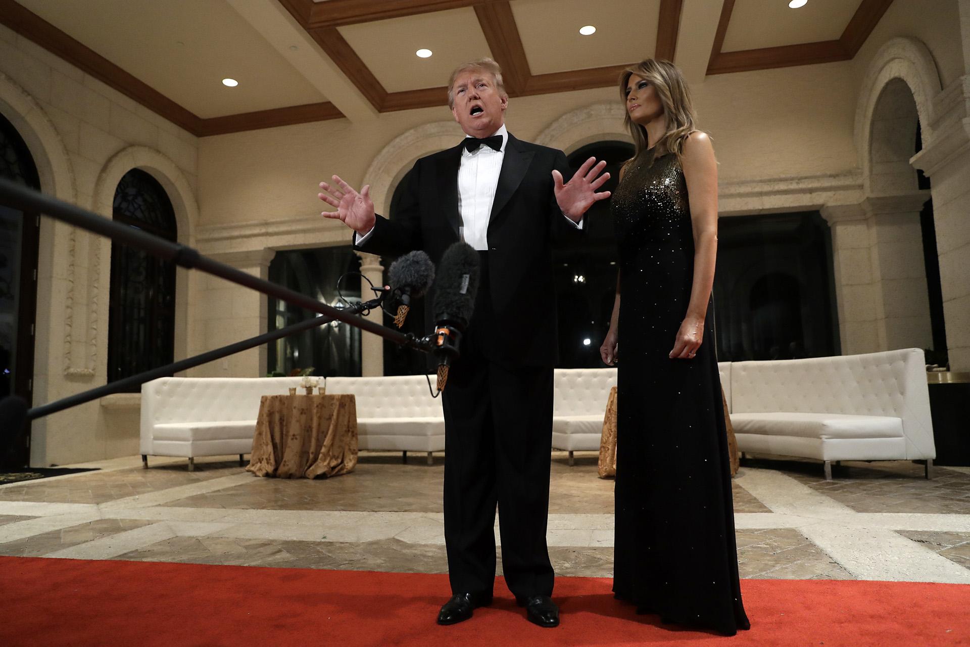 President Donald Trump speaks to the media about the situation at the U.S. embassy in Baghdad, from his Mar-a-Lago property, Tuesday, Dec. 31, 2019, in Palm Beach, Florida, as Melania Trump stands next to him. (AP Photo / Evan Vucci)