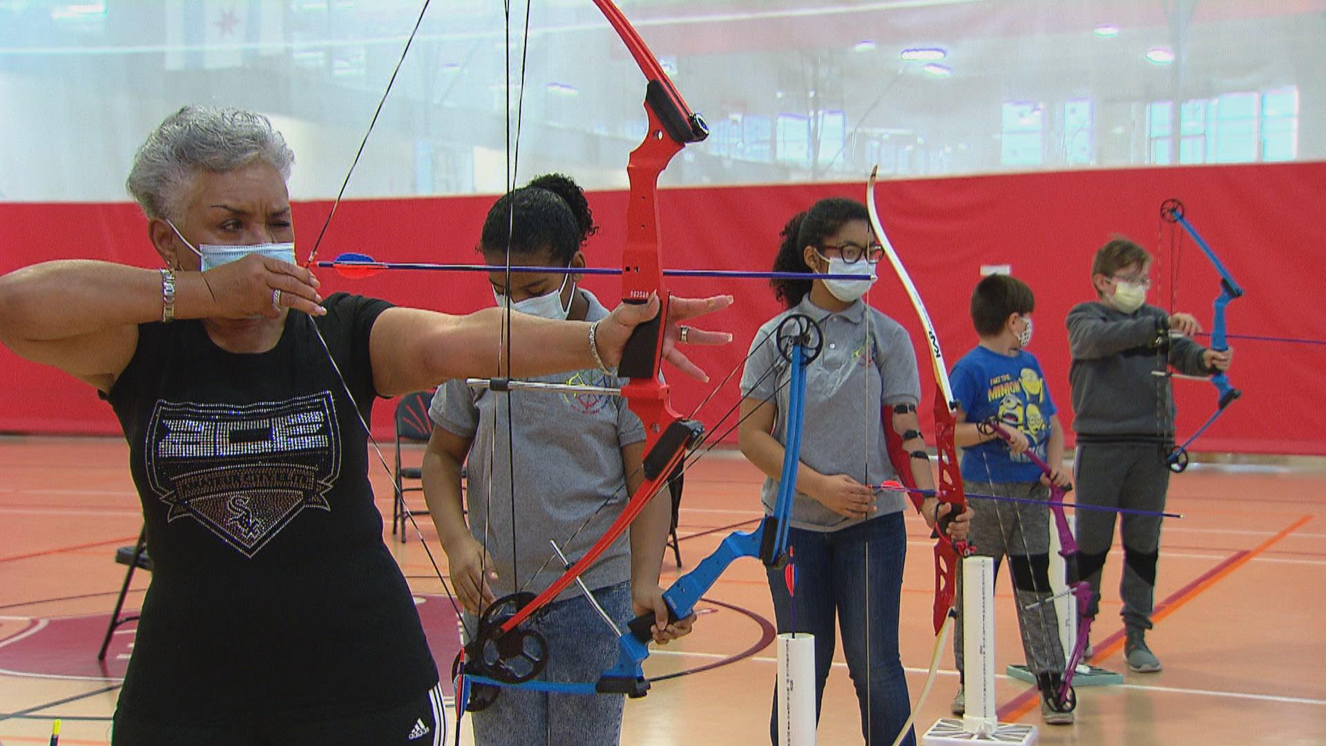 Archers practice their shooting during a lesson held by the Chicago Archery Club at the Kroc Center Chicago on Nov. 19, 2020. (WTTW News)