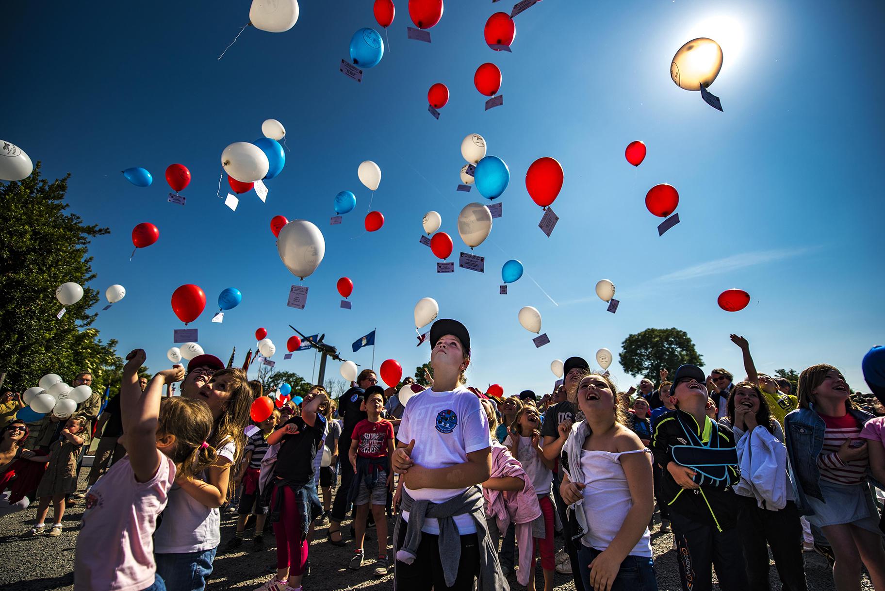 French children release balloons into the air during a D-Day remembrance ceremony at the United States Army Air Forces Transport Memorial in Picauville, France, June 1, 2017. (U.S. Air Force photo / Senior Airman Devin Boyer)