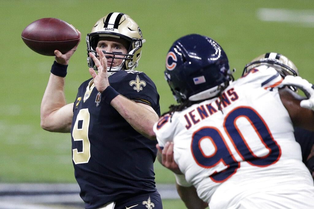 New Orleans Saints quarterback Drew Brees (9) passes under pressure from Chicago Bears defensive tackle John Jenkins (90) in the second half of an NFL wild-card playoff football game in New Orleans, Sunday, Jan. 10, 2021. (AP Photo / Butch Dill)