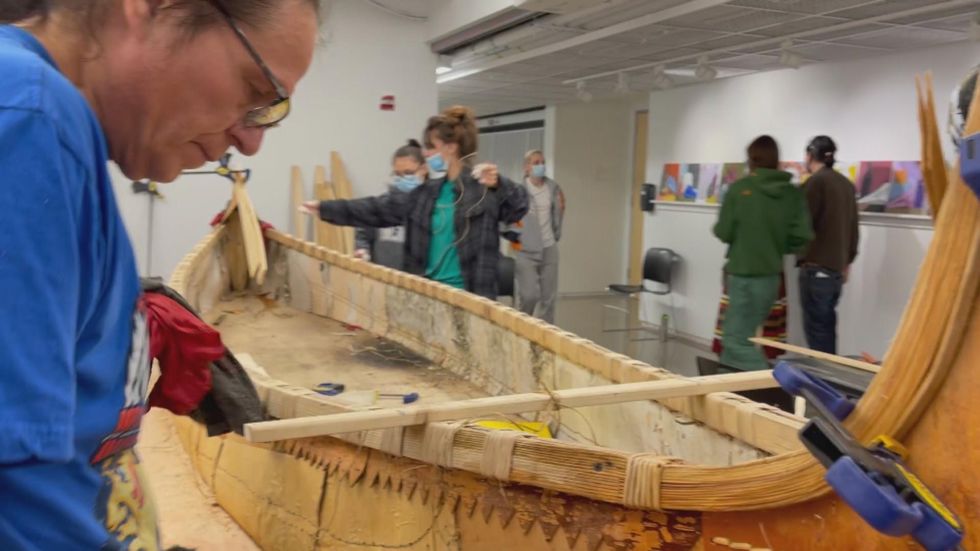 Wayne Valliere, a member of the Lac du Flambeau Band of Lake Superior Ojibwe, builds a 16-foot birchbark canoe at Northwestern University. (Courtesy: Northwestern University)