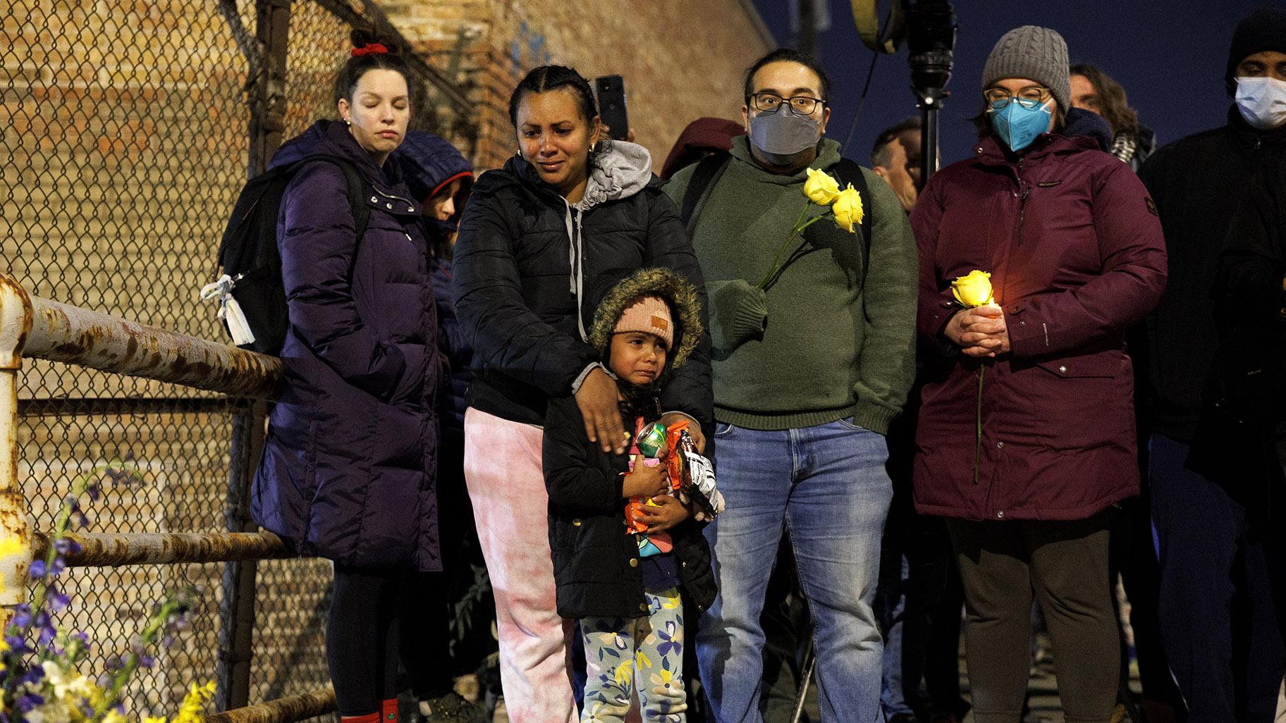 A woman and child cry while attending a vigil for 5-year-old Jean Carlos Martinez Rivero, who died over the weekend at the Lower West Side shelter, Wednesday, Dec. 20, 2023, in Chicago. (Armando L. Sanchez / Chicago Tribune via AP)
