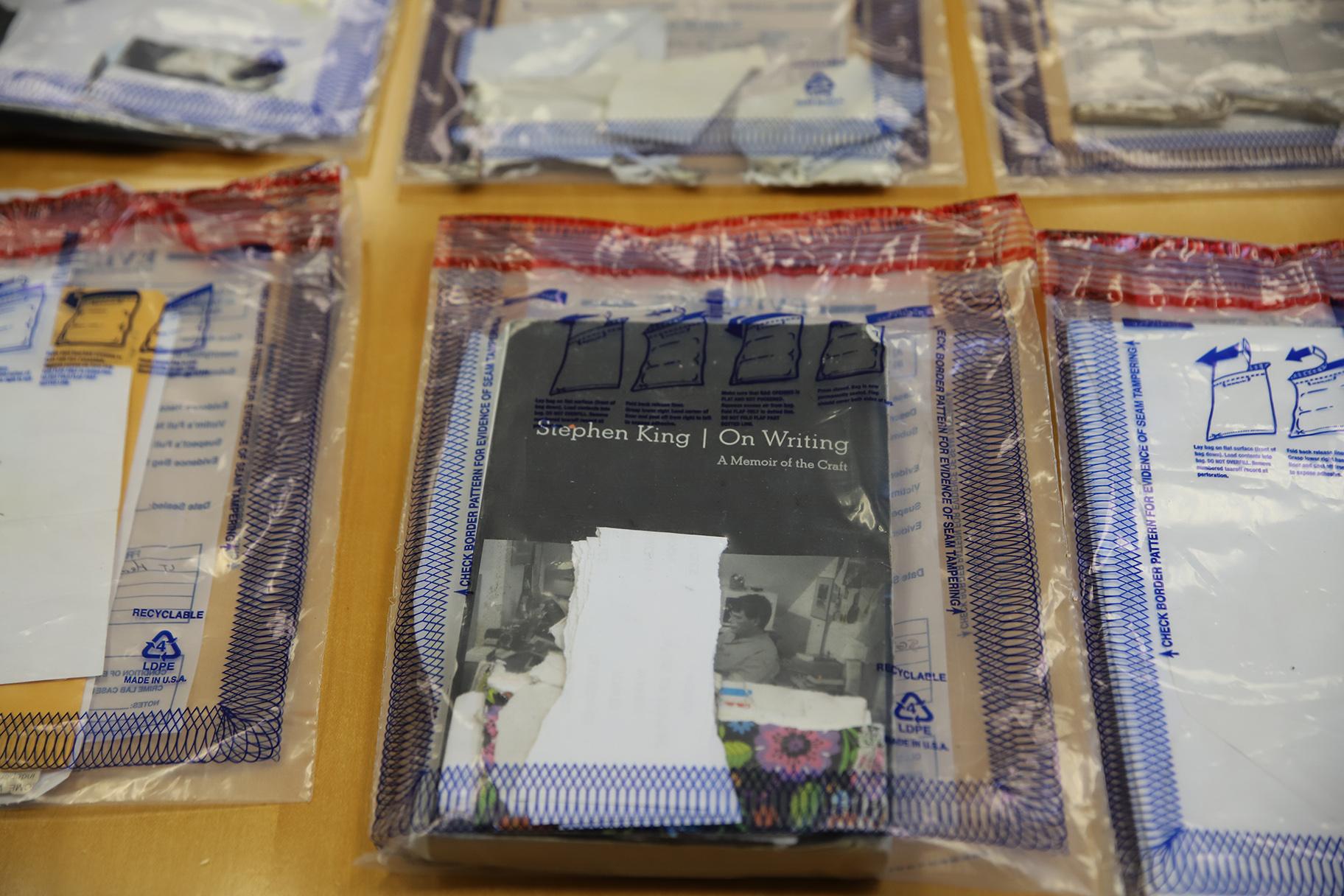Bags of evidence lay on a table at Cook County Jail on Oct. 12. Books like "On Writing" by Stephen King were found as evidence having drug-soaked paper inside. (Cary Robbins / DePaul)