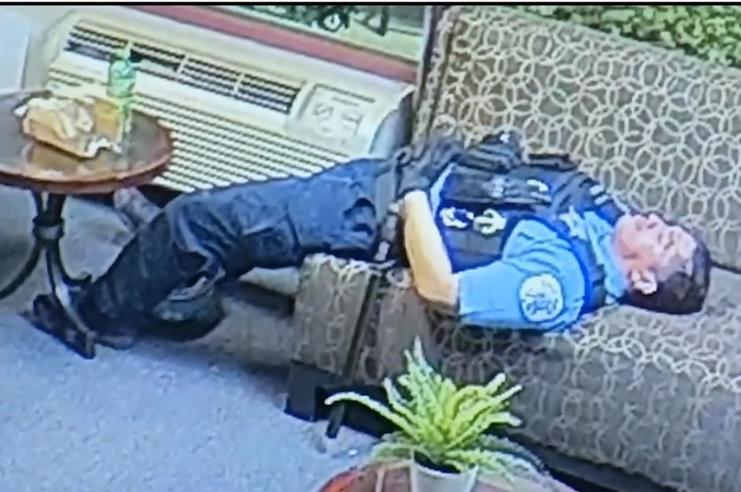 A screenshot from a video shown to the media on Thursday, June 11, 2020 shows a Chicago police officer lying down inside the office of U.S. Rep. Bobby Rush. (WTTW News via City of Chicago)