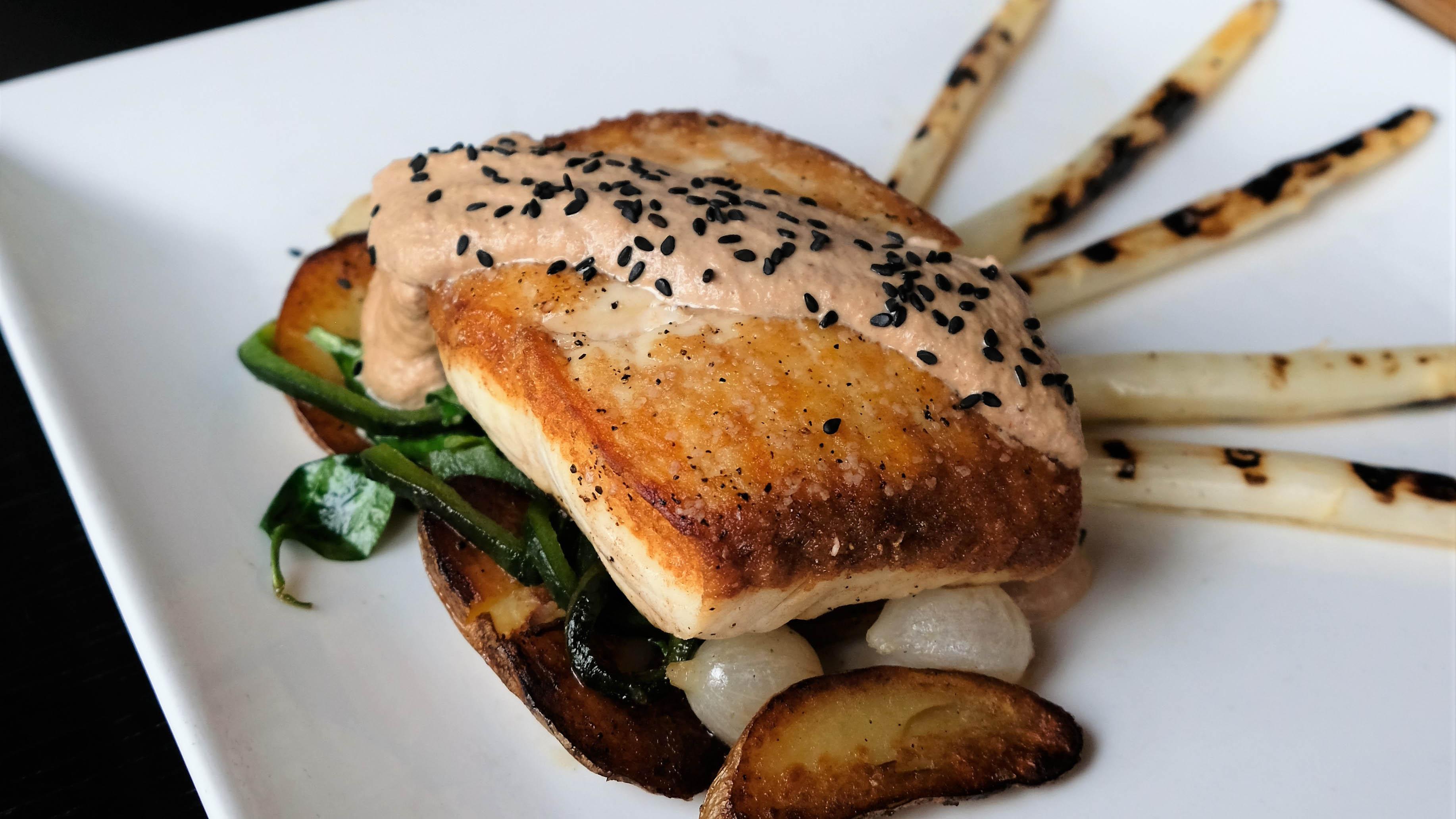 El Palomo by Café Con Leche features pan seared white fish, roasted fingerling potatoes, poblano peppers, spinach, white onion pearls and white mole sauce. (Courtesy of Café Con Leche)
