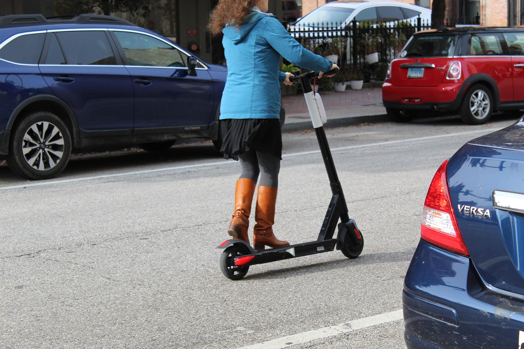 A woman rides an electric scooter in Baltimore on Nov. 18, 2018. (Elvert Barnes / Flickr) 
