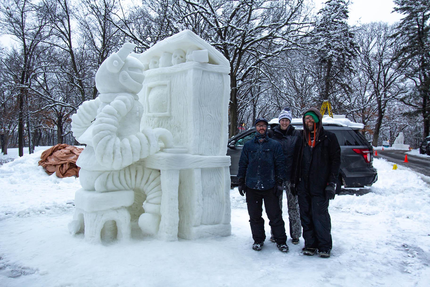 The winners of the 34th annual Illinois Snow Sculpting Competition, a team called Cave People from Space, pose next to their sculpture “Player Piano” on Saturday. (Courtesy Rockford Park District)