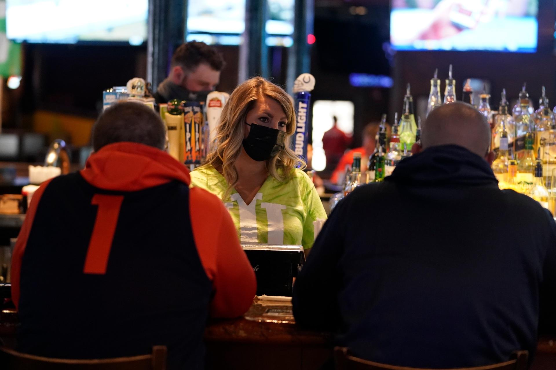 Jillian Smith takes an order from people at Kilroy’s Bar & Grill, Sunday, March 14, 2021, in Indianapolis. (AP Photo / Darron Cummings)