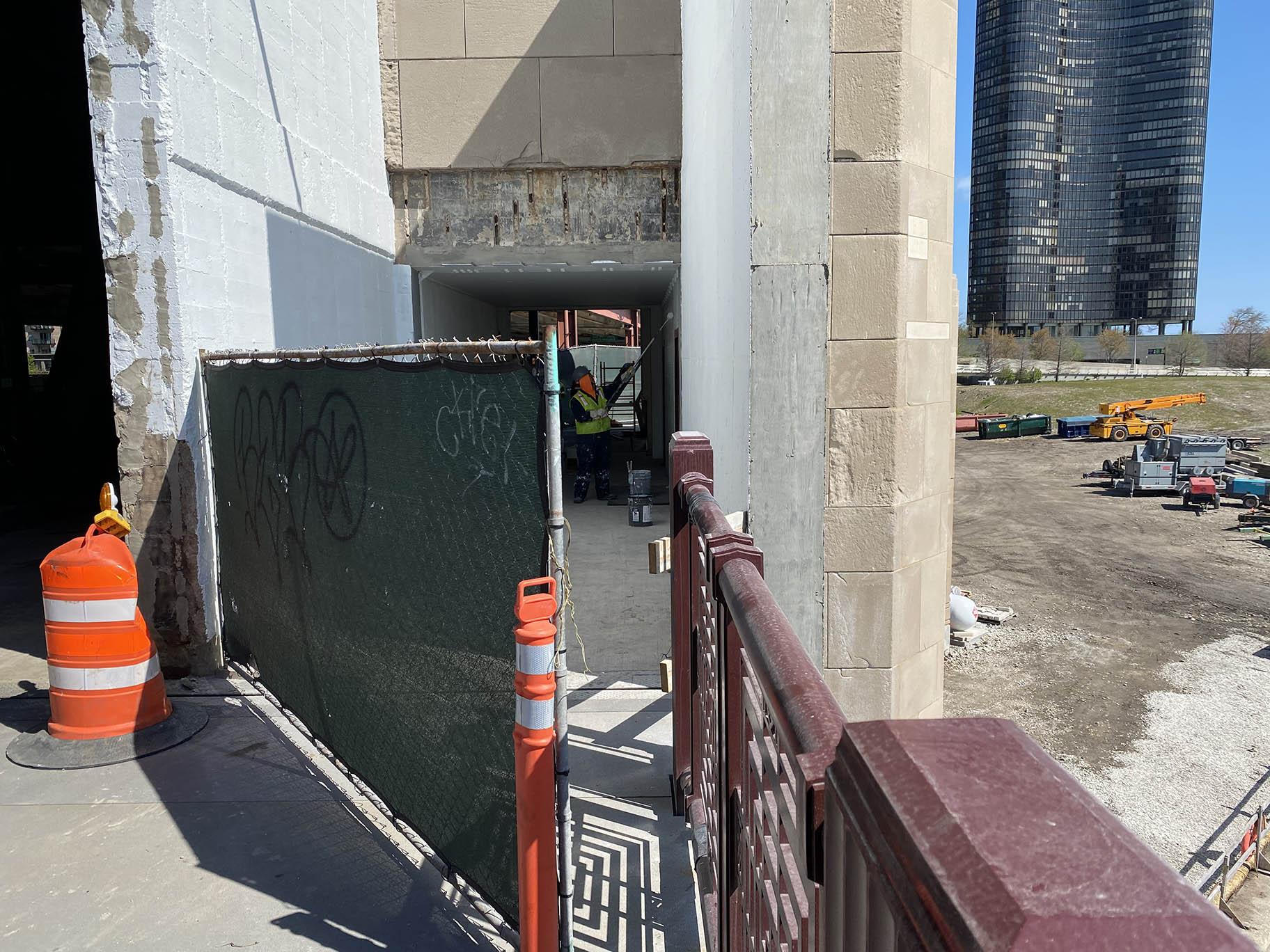Crews work to paint the inside of a bridge house that was tunneled through to accommodate runners and cyclists on the Navy Pier Flyover portion of the lakefront trail, April 30, 2021. (Nick Blumberg / WTTW News)