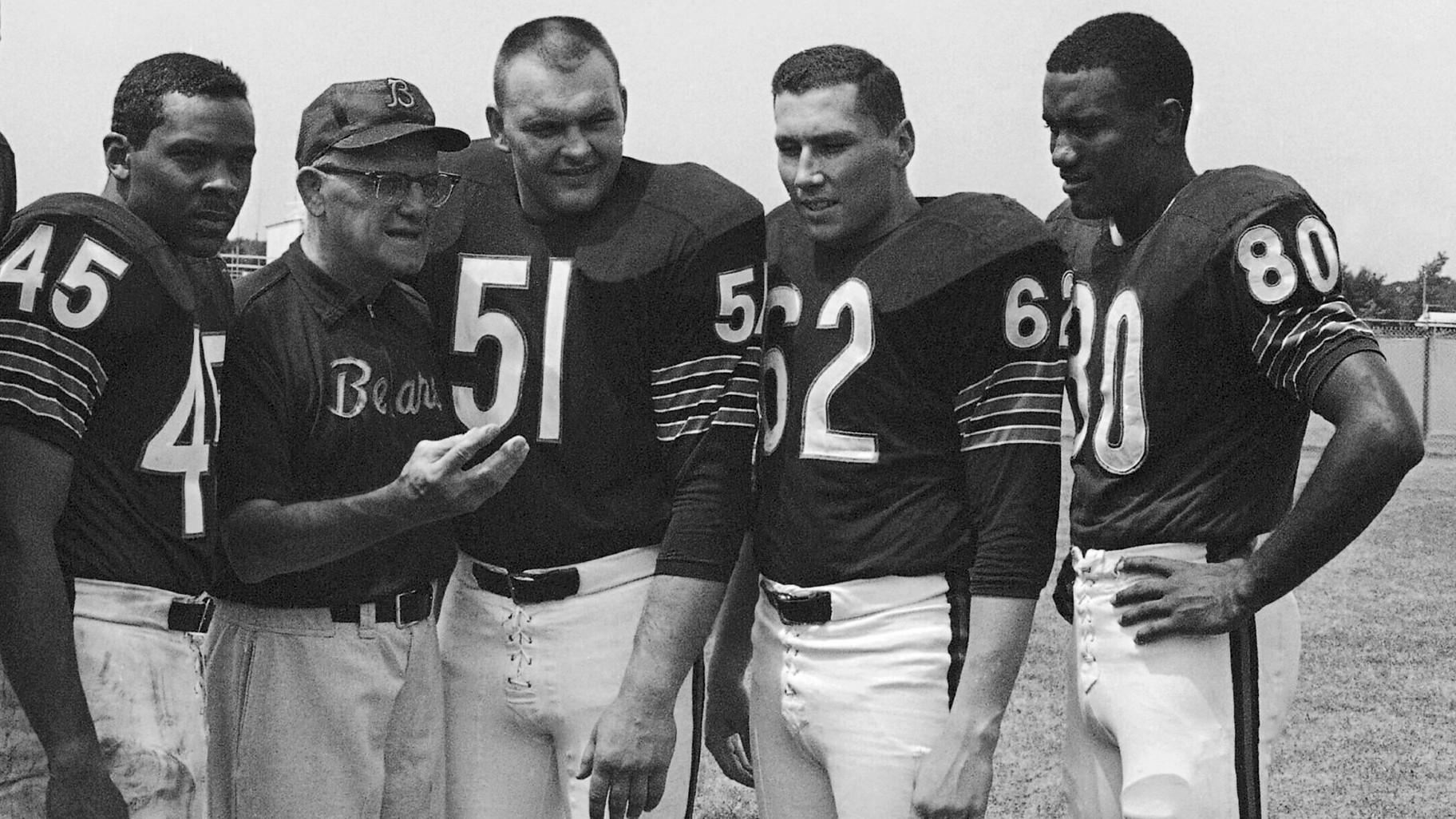 FILE - Chicago Bears coach George Halas discusses the upcoming season with four of his second-year men at training camp in July 1966 at St. Joseph's College in Rensselaer, Ind. With Halas at picture session are Dick Gordon (45), Dick Butkus (51), Mike Reilly (62) and Jimmy Jones (80). (AP Photo, File)