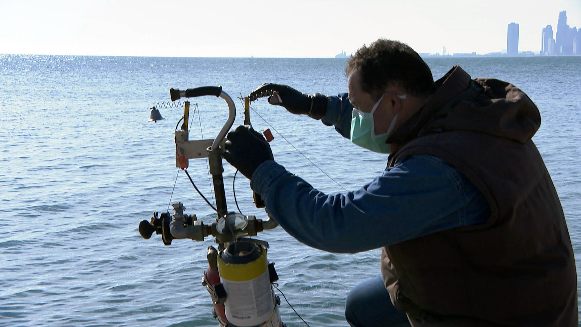 Florin Deleanu adjusts his powerline fishing setup. (WTTW News)