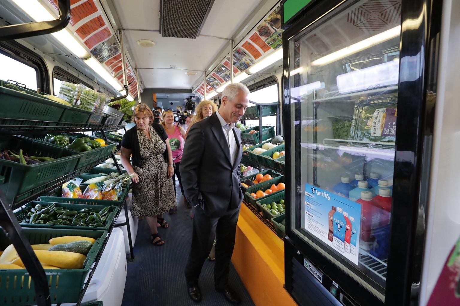 Mayor Rahm Emanuel tours a mobile market operated by the Urban Growers Collective during an event on Aug. 22, 2018. (Courtesy City of Chicago)