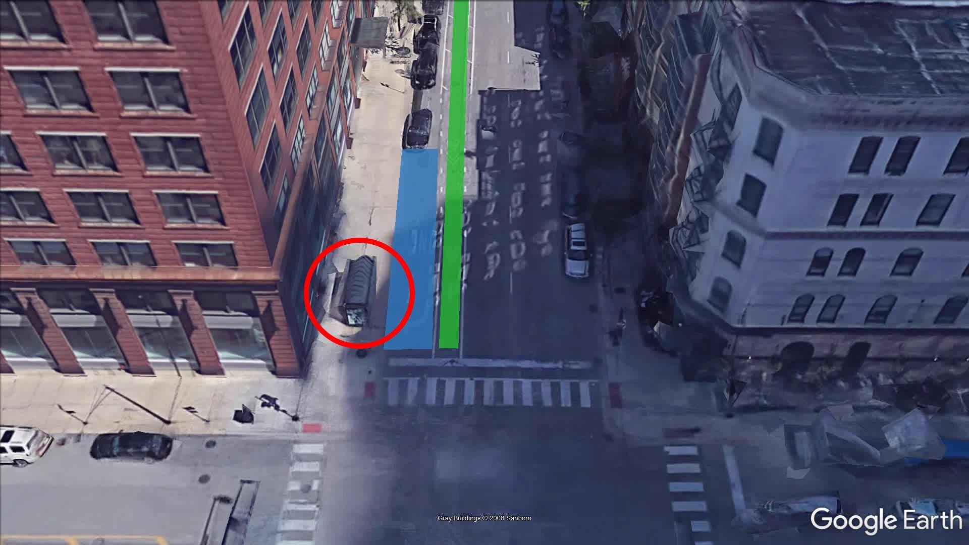 An aerial view of the intersection of Wells and Hubbard streets, looking north. A CTA bus struck a cyclist near the intersection in June 2019. According to police, the bus was pulling up to the bus stop, circled, and the cyclist was riding in the bike lane, in green. The bus lane is highlighted in blue. (Google Earth)