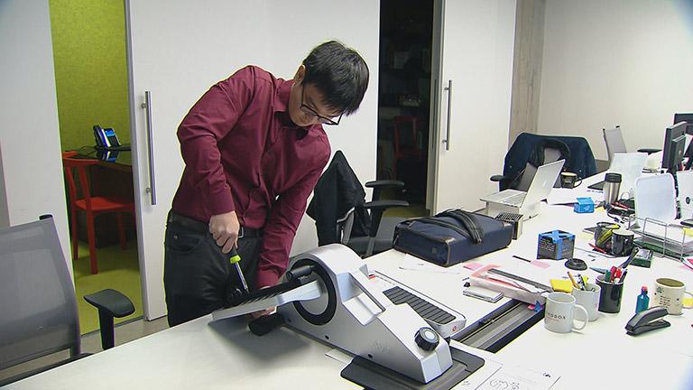 Ryota Sekine, a co-founder of Cubii, works on the small, under-the-desk elliptical machine.