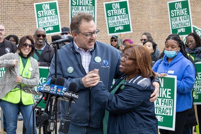 Valerie Goss, the head of the faculty union at Chicago State University, and Illinois Federation of Teachers President Daniel Montgomery embrace at an April 3, 2023, rally on the campus of Chicago State University. (Andrew Adams / Capitol News Illinois)