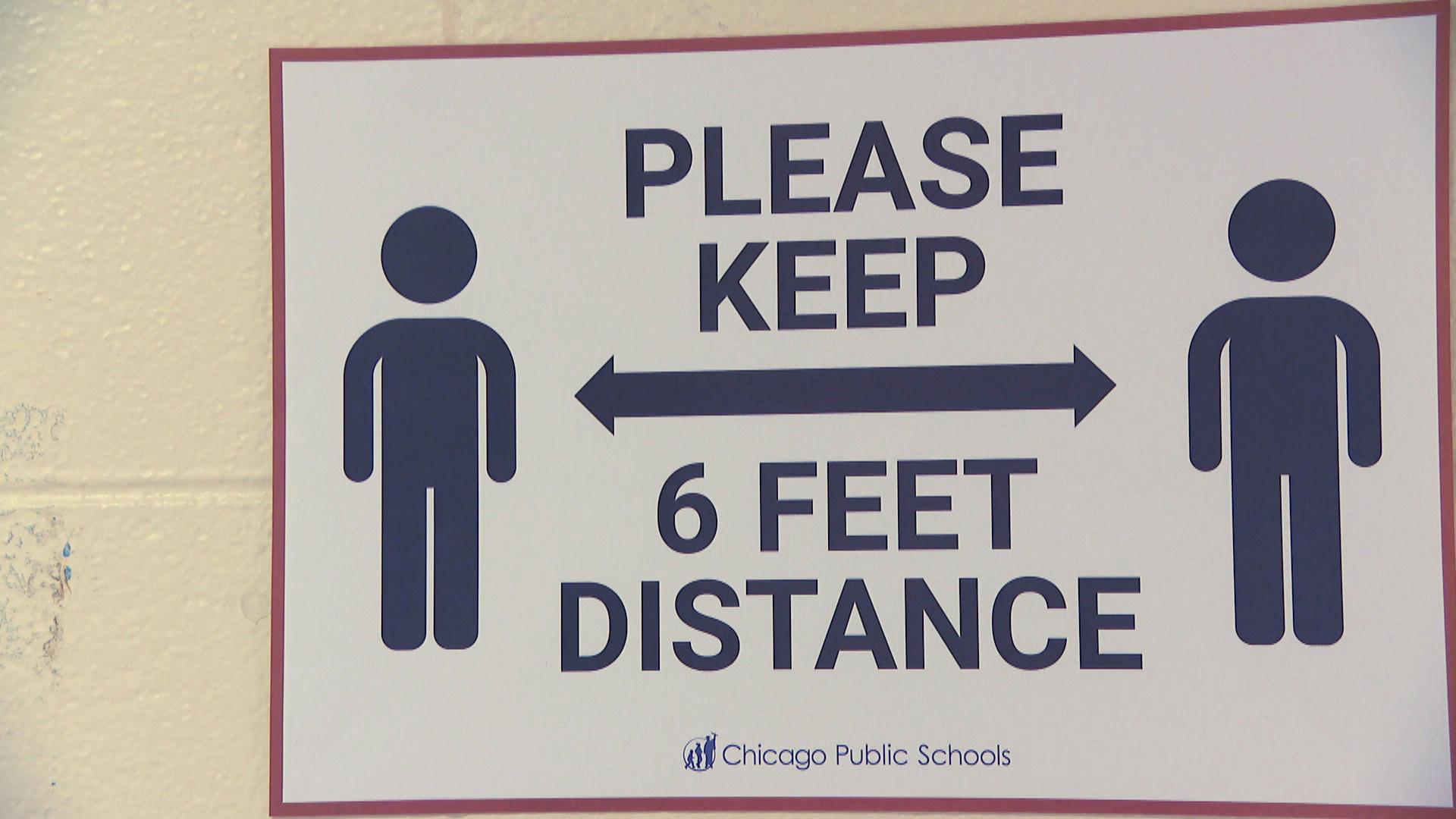 A sign promoting social distancing is shown inside a Chicago Public Schools building. (WTTW News)