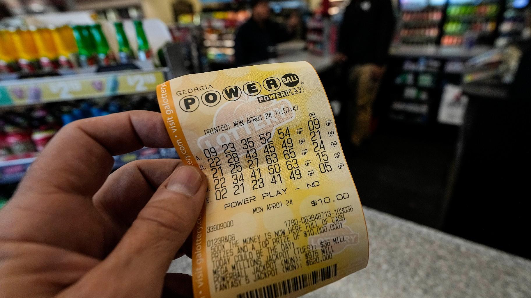 A Powerball lottery ticket is dipslayed seen inside a convenience store, Monday, April 1, 2024, in Kennesaw, Ga. An estimated .09 billion Powerball jackpot that ranks as the 9th largest in U.S. lottery history will be up for grabs Wednesday night, April 3. (AP Photo / Mike Stewart, FIle)