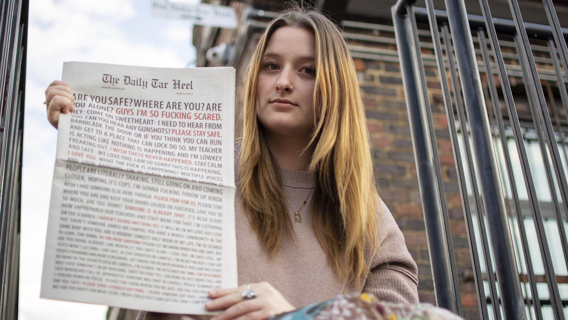 Emmy Martin, Editor in Chief of The Daily Tar Heel, the student newspaper of the University of North Carolina at Chapel Hill, poses with a copy of the Aug. 30 paper outside of the newsroom on Monday, Oct. 9, 2023, in Chapel Hill, N.C. (Samantha Lewis via AP)