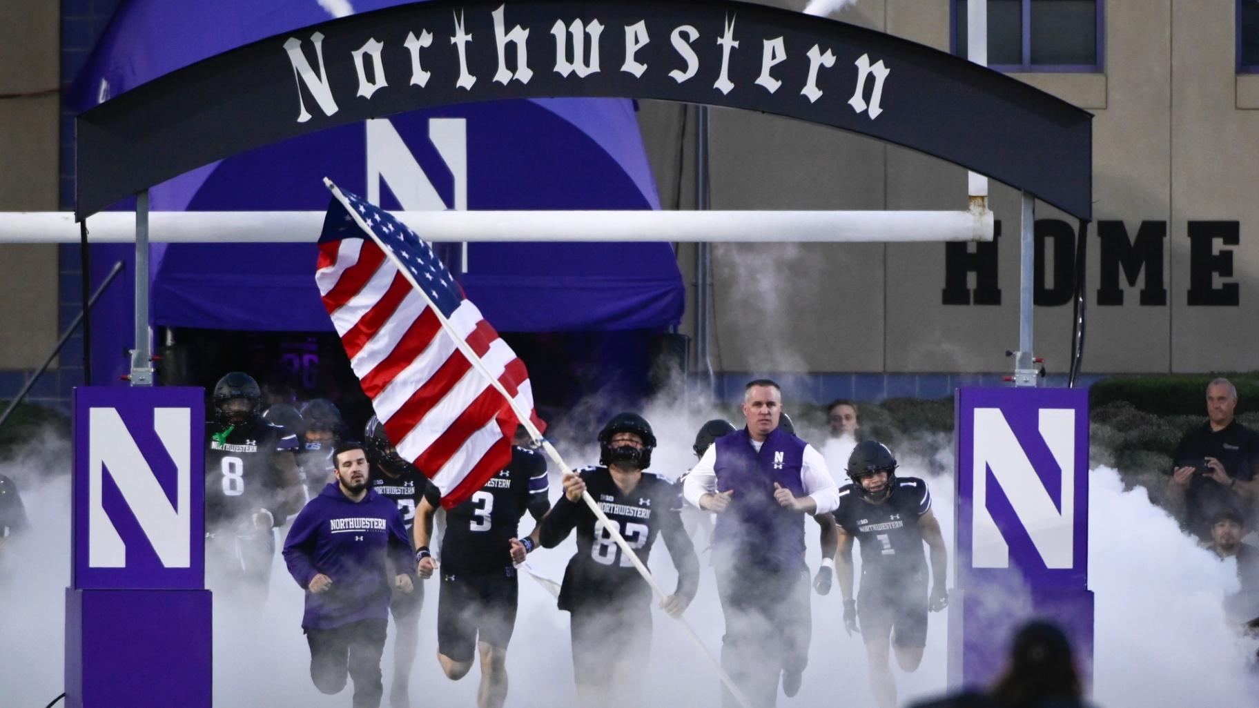 FILE - Northwestern coach Pat Fitzgerald, right, leads the team onto the field for the team's NCAA college football game against Miami (Ohio) on Sept. 24, 2022, in Evanston, Ill. (Matt Marton / AP Photo, File)