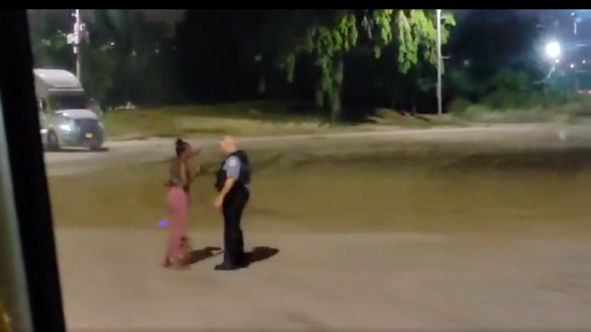 A still image taken from video provided to WTTW News shows Nikkita Brown and a Chicago police officer at North Avenue Beach around 12:12 a.m. Saturday, Aug. 28, 2021. (Courtesy of Saulter Law P.C.)