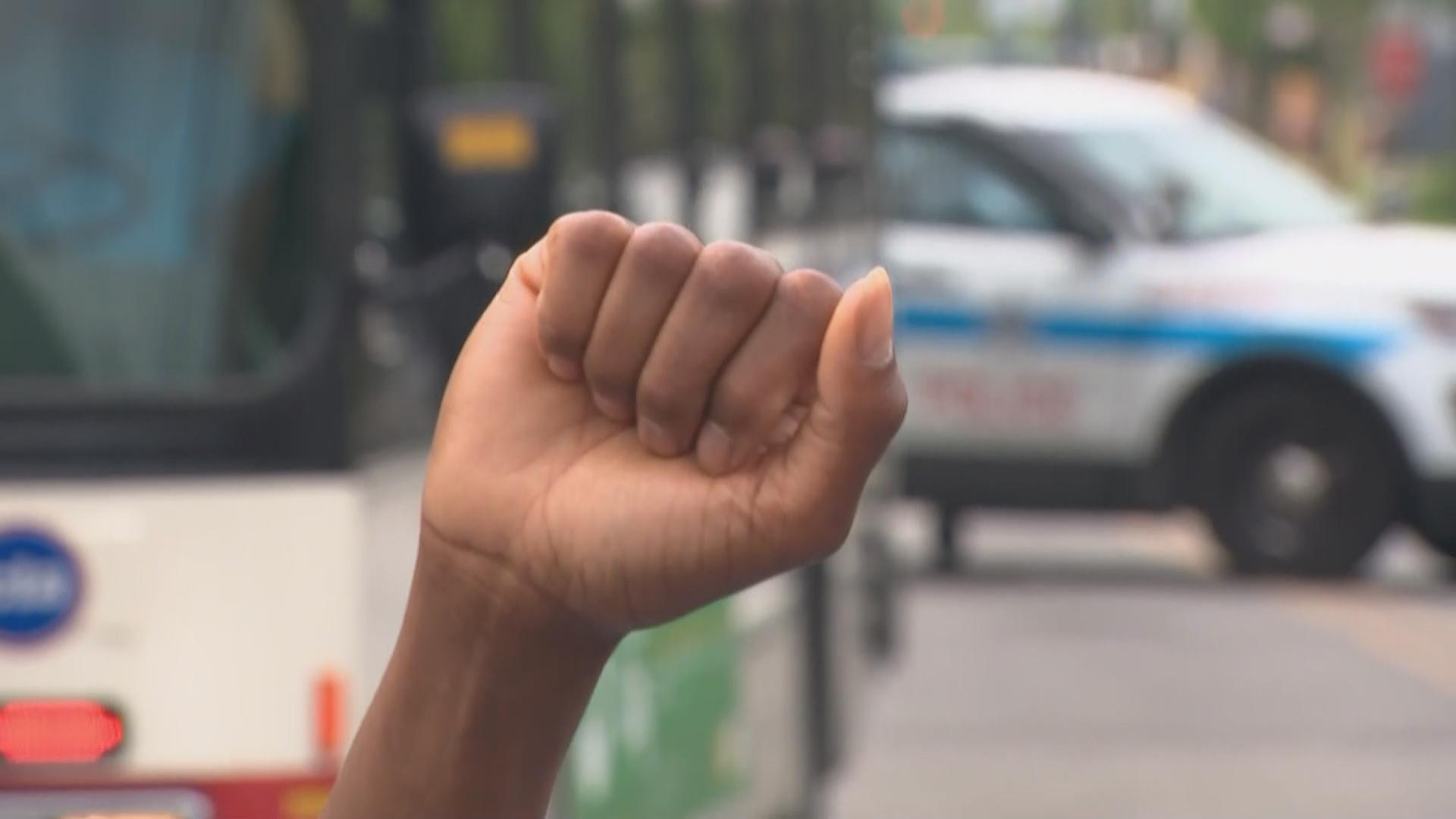 A demonstrator raises a fist during a peace rally organized by St. Sabina Church on June 4, 2020 in Chicago. Some activists and officials are concerned that federal agents coming to Chicago will exacerbate violence, including clashes between protesters and police. (WTTW News)