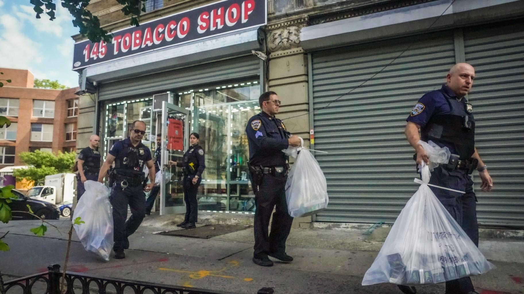 Law enforcement members of New York Sheriff's Joint Compliance Task Force (SJCTF) carry bags of confiscated vaping products, during a spot raid of a tobacco shop, Wednesday Sept. 27, 2023, in New York. (Bebeto Matthews / AP Photo)