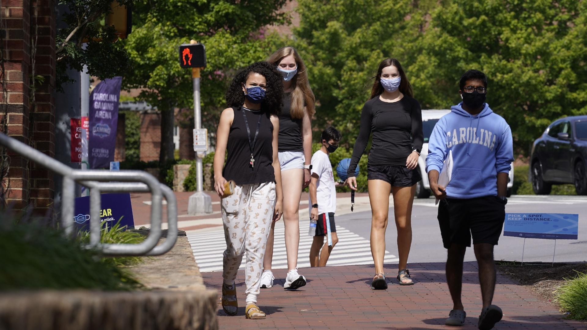 In this Aug. 18, 2020, file photo, students wear masks on campus at the University of North Carolina in Chapel Hill, N.C. (AP Photo/Gerry Broome, File)