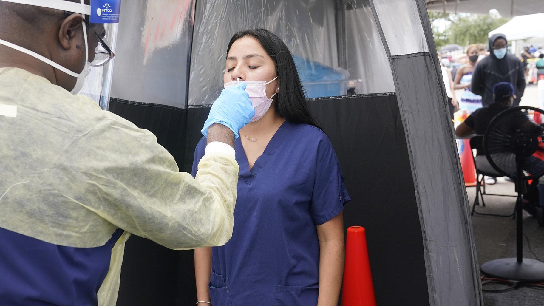 Janice Perez, a clinical technician, is tested for COVID-19, after a colleague at her office recently tested positive, Monday, Aug. 9, 2021, in North Miami.  (AP Photo / Marta Lavandier)