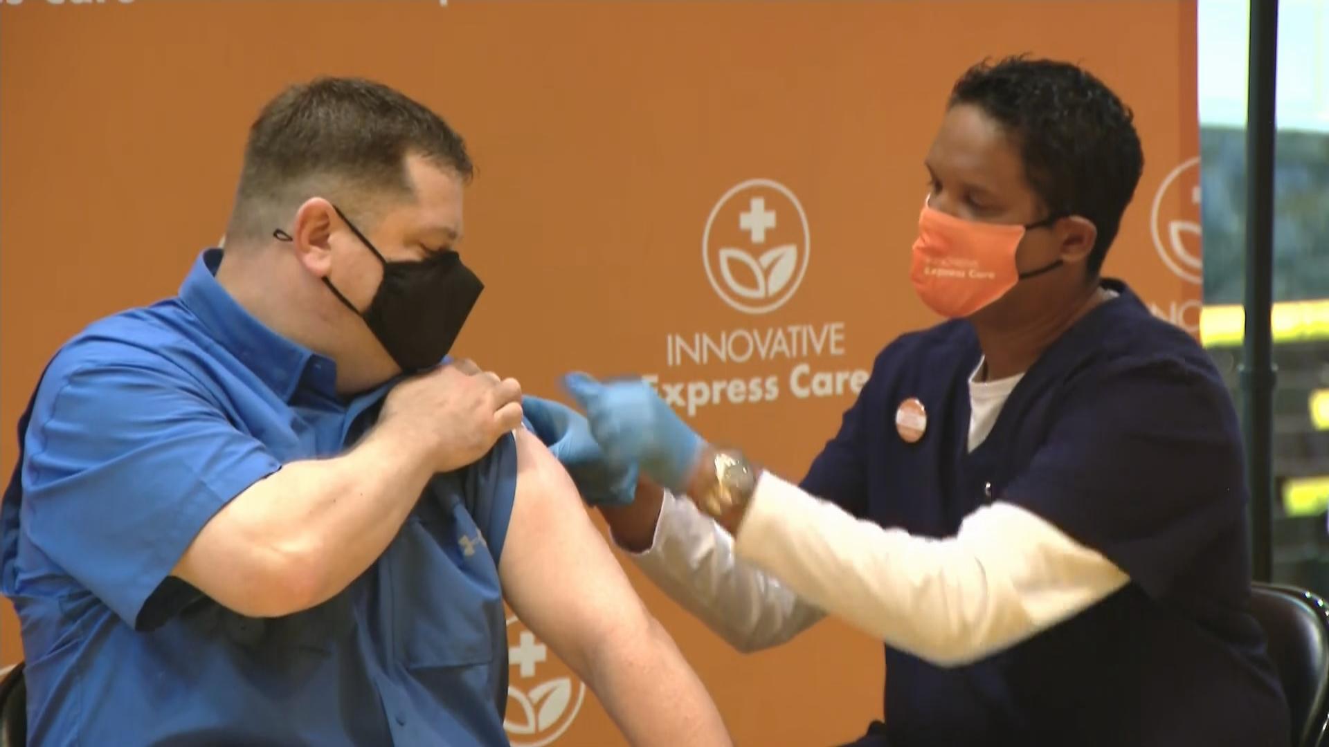 Jeff Lorenz, a teacher at Roosevelt High School, receives a COVID-19 vaccination at his school on March 17, 2021. (WTTW News)