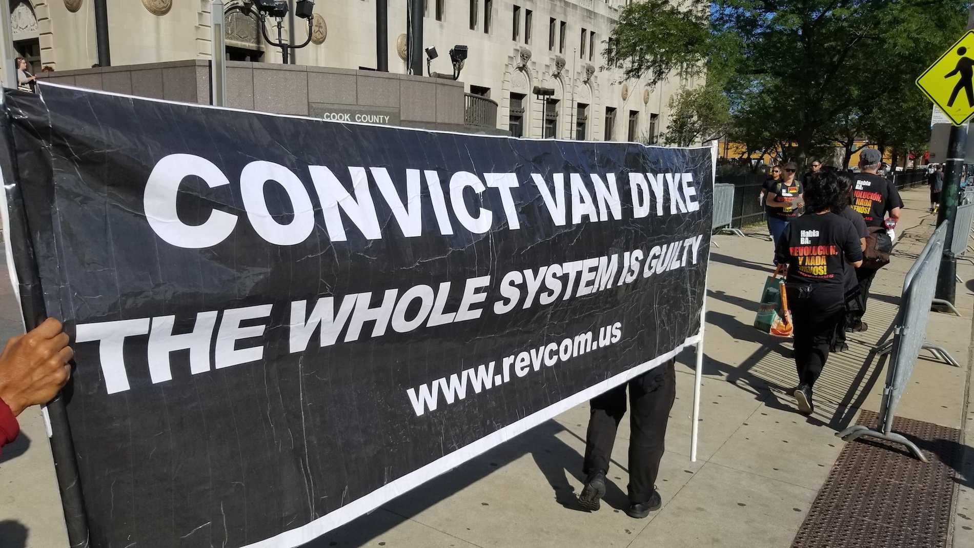 Protesters stand outside the Leighton Criminal Court building Monday, Sept. 10, 2018, the first day of jury selection in Jason Van Dyke’s murder trial. (Matt Masterson / Chicago Tonight)
