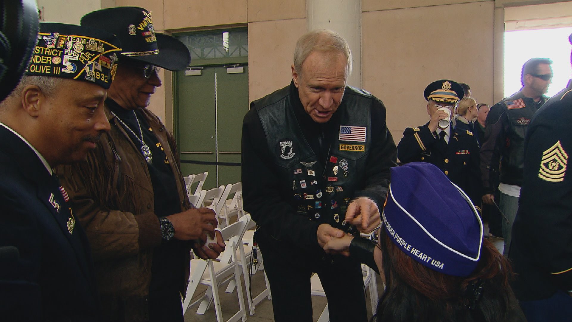Gov. Bruce Rauner greets a veteran at Wednesday's Veteran's Day ceremony at Soldier Field.