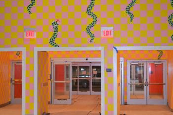 Snakes, and pink and yellow checker shapes, draw focus to this entranceway by artist Jim Drain